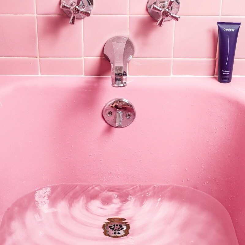 white bathtub filled with water