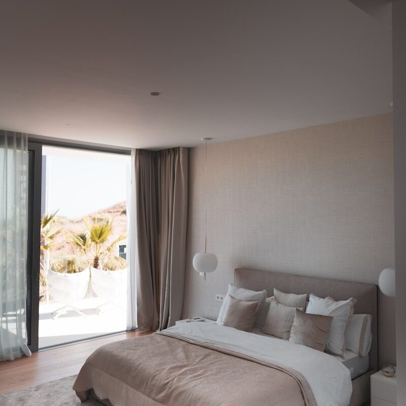 white bed linen near window